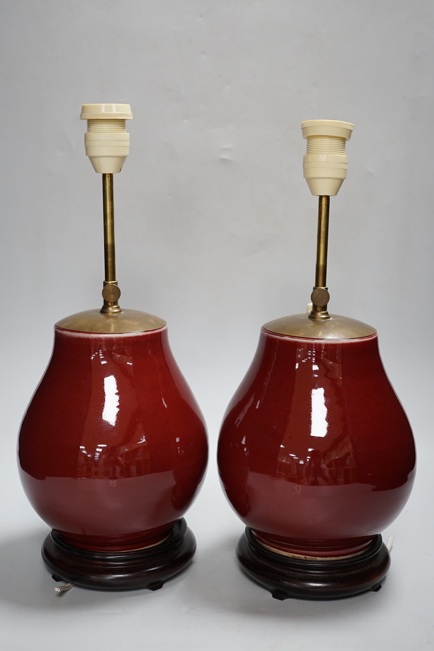 A pair of Chinese sang de boeuf glazed vases, mounted as lamps 23cm high excluding light fitting